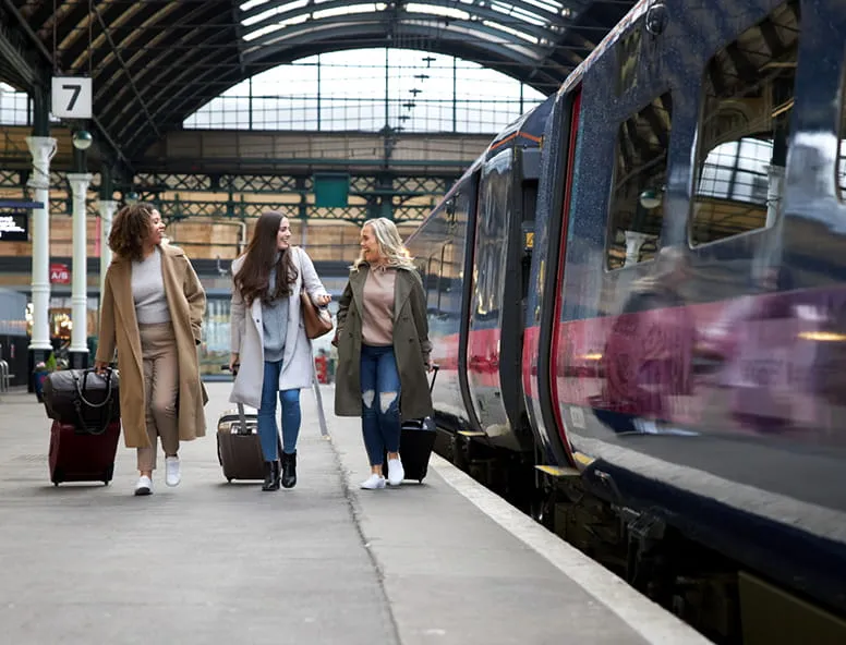 A group of friends on the platform next to a Hull Trains services
