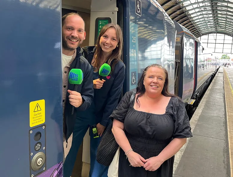 Hits Radio presenters and winner onboard a Hull Trains service