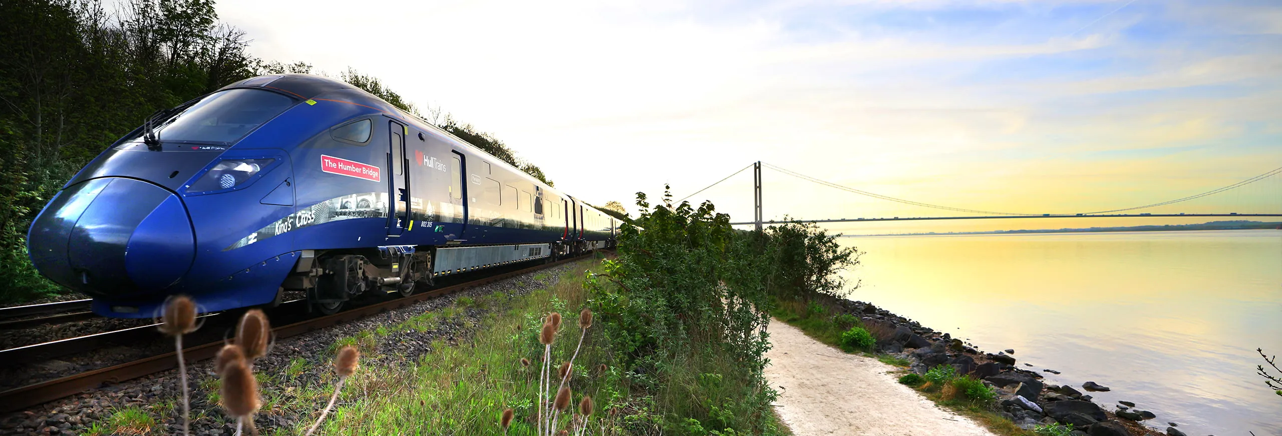 Hull Trains with the Humber Bridge and a sunset
