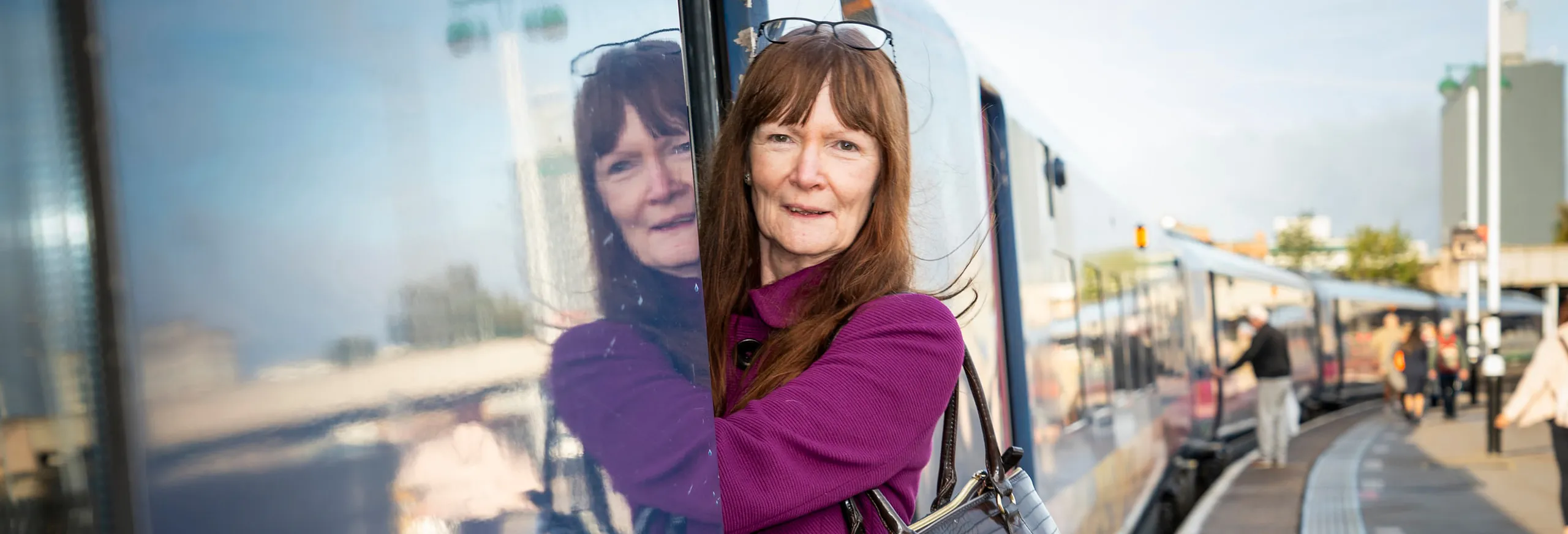 A person boarding a train at a station