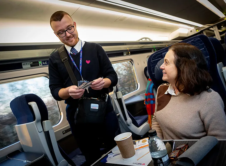 A Hull Trains Onboard Manager checking a customers ticket for travel
