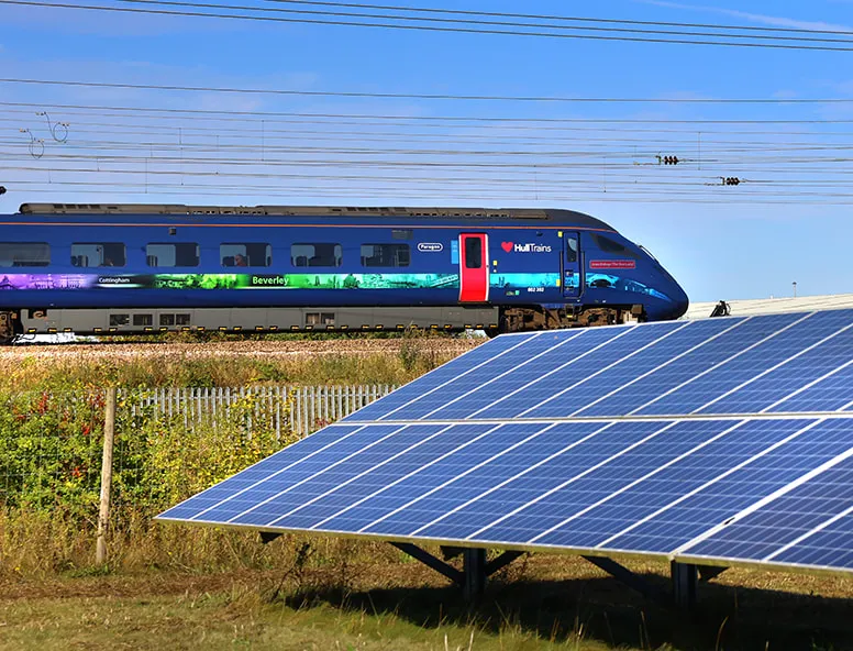 Hull Trains service passing through a field of solar panels