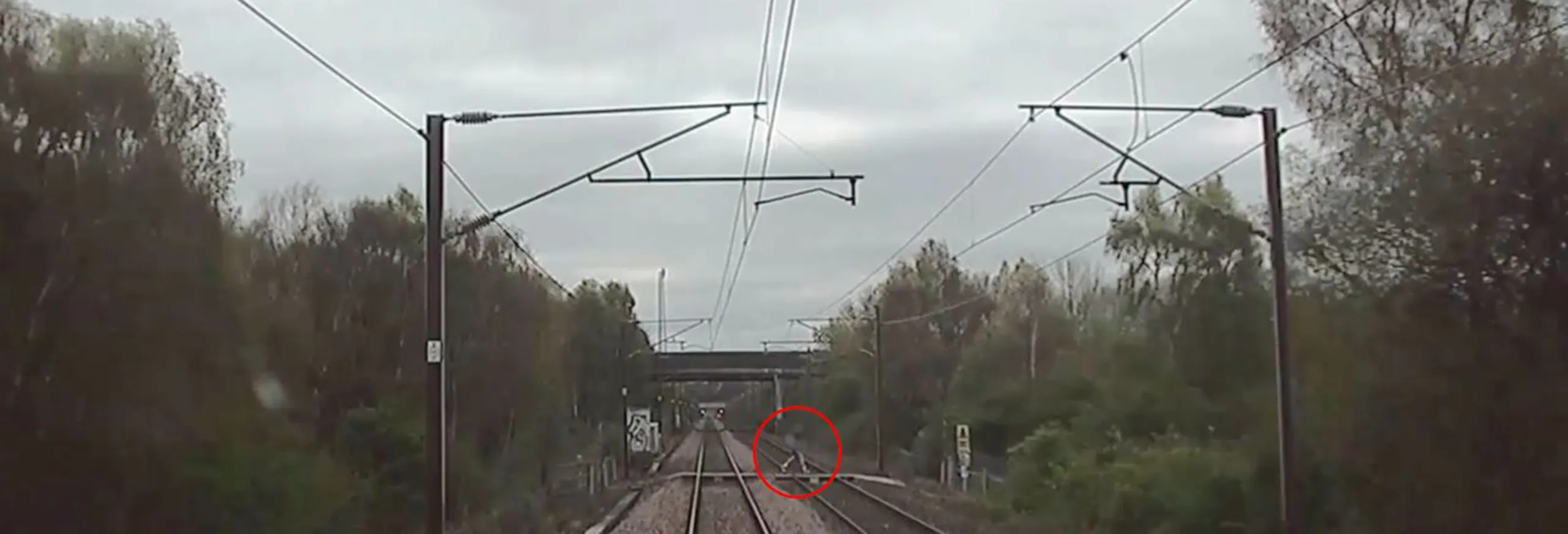 A person circled crossing train tracks as a train is approaching at 100mph