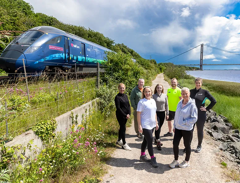 A group of Hull Trains colleagues with the train for their walking the route challenge