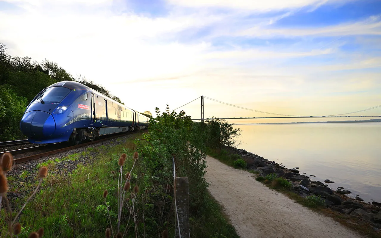 Hull Trains passing the Humber Bridge and water