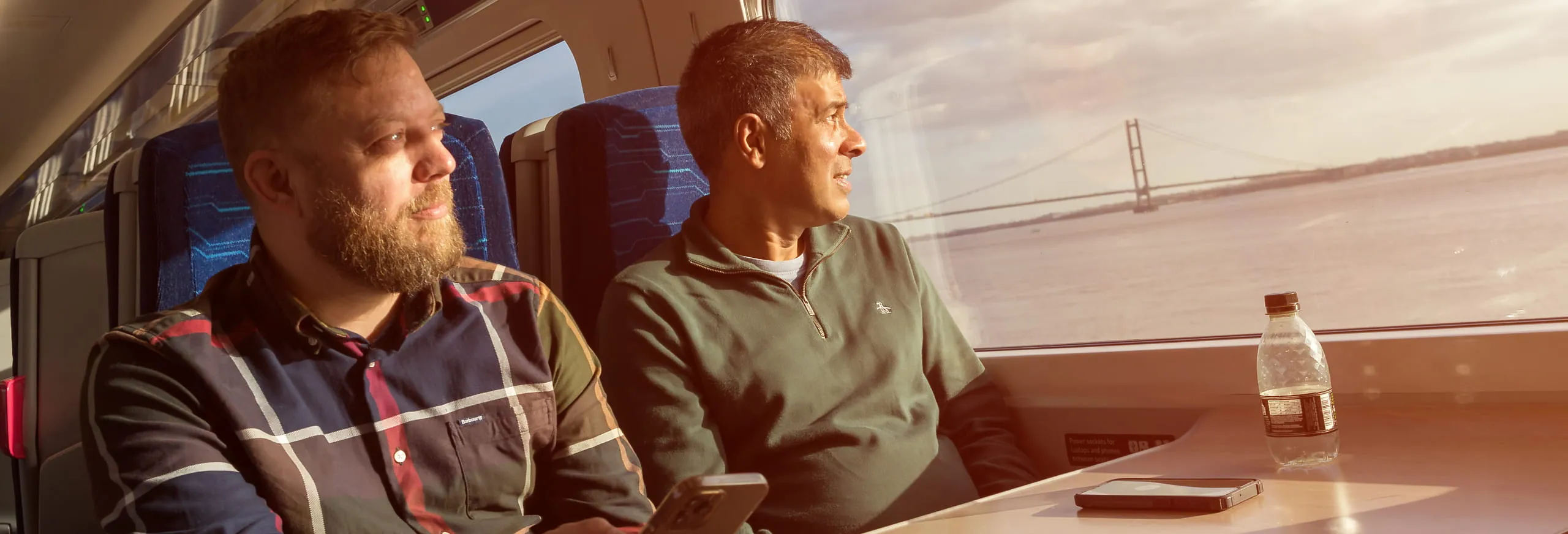 Passengers looking at the sunset and humber bridge hull